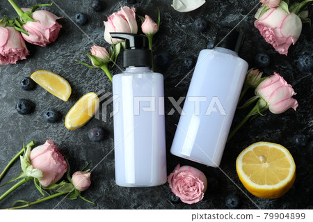 Natural shower gels and ingredients on black smokey background Natural shower gels and ingredients on black smokey background 79904899