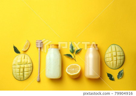 Natural mango shower gel and ingredients on yellow background Natural mango shower gel and ingredients on yellow background 79904916
