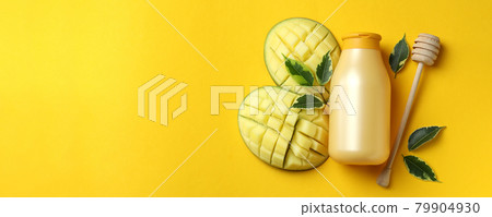 Natural mango shower gel and ingredients on yellow background Natural mango shower gel and ingredients on yellow background 79904930
