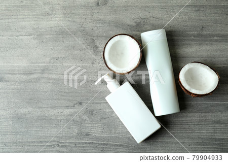 Shower gels and coconut on gray textured background Shower gels and coconut on gray textured background 79904933
