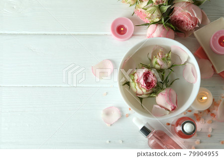 Skin care concept with essential rose oil on white wooden table 79904955