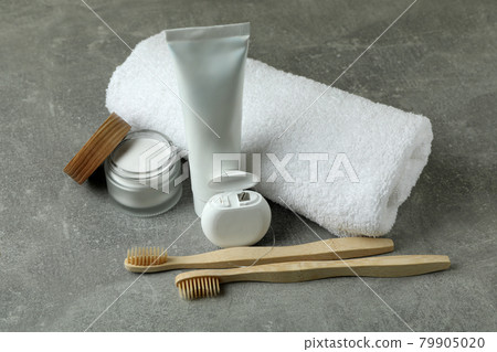 Oral care accessories on gray textured background 79905020