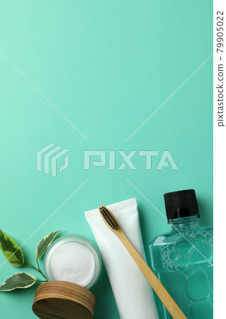 Oral care accessories on mint background, space for text 79905022