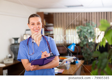 Female doctor assistant standing in medical office Female doctor assistant standing in medical office 79905385