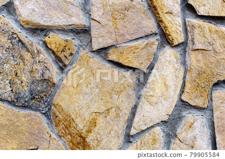 Texture of brown stones laying in pieces. Covering the walls with natural stones 79905584