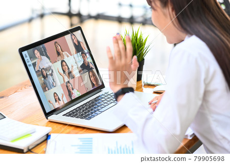Female employee talking on video call with diverse colleagues on laptop computer. Female employee talking on video call with diverse colleagues on laptop computer. 79905698