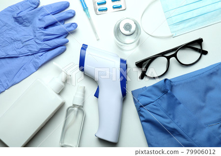 Medical tools and thermometer gun on white background Medical tools and thermometer gun on white background 79906012