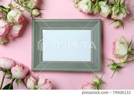 Roses and empty frame on pink background Roses and empty frame on pink background 79906132