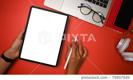 Overhead shot creative woman holding stylus pen and digital tablet. 79907680