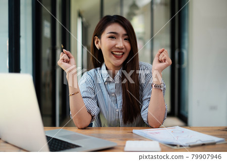 Joyful businesswoman sitting at desk looking at laptop screen talking with friend make informal video call Joyful businesswoman sitting at desk looking at laptop screen talking with friend make informal video call 79907946