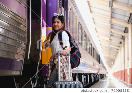 Alone traveler tourist wear mask with backpack at train station. work and travel lifestyle concept. Alone traveler tourist wear mask with backpack at train station. work and travel lifestyle concept. 79908318