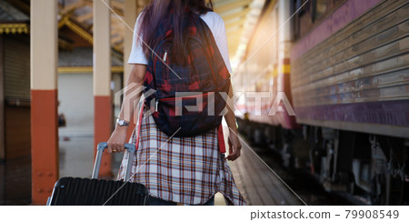 Alone traveler tourist walking with backpack and luggage at train station. work and travel lifestyle concept. 79908549