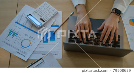 Business woman trader investor using laptop with paperwork stock market graph on desk. stock chart, investment concept. 79908659