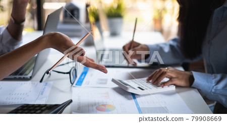 At the corporate headquarters, a business team works and discusses in a private meeting room At the corporate headquarters, a business team works and discusses in a private meeting room 79908669