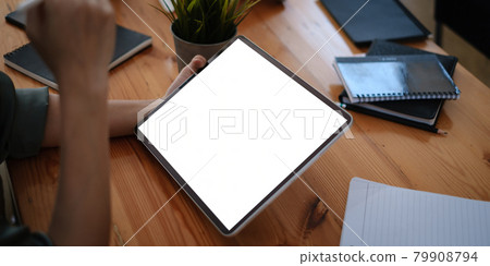 Mockup digital tablet on businesswoman hand with blank screen. Business people meeting and brainstorming by video conference. 79908794