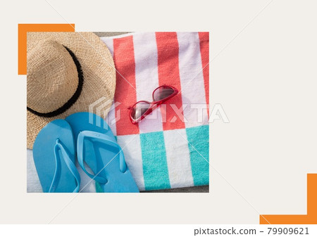 Photograph of flip flops, sunglasses and starfish against grey background 79909621
