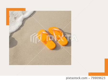 Photograph of orange flip flops at the beach against grey background Photograph of orange flip flops at the beach against grey background 79909623