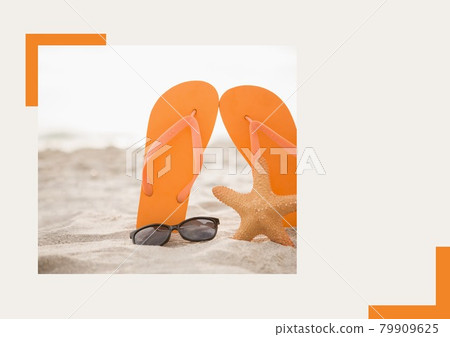 Photograph of flip flops, sunglasses and starfish at the beach against grey background 79909625