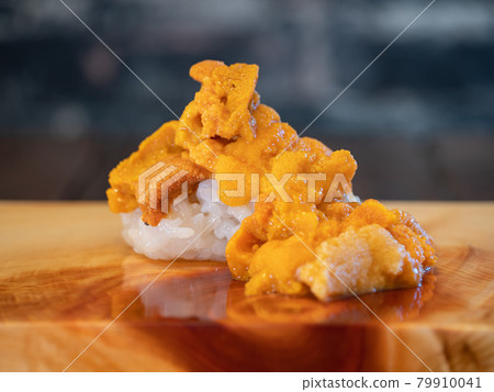 Nigiri sushi on top so that raw sea urchin of high-class seafood spills. Nigiri sushi on top so that raw sea urchin of high-class seafood spills. 79910041