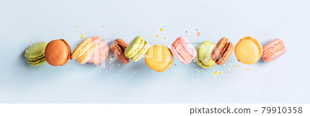 Vintage pastel colored French macaroons or macarons in motion falling on light blue background Vintage pastel colored French macaroons or macarons in motion falling on light blue background 79910358