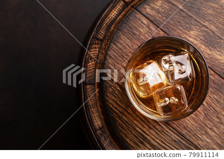 Scotch whiskey glass and old barrel 79911114