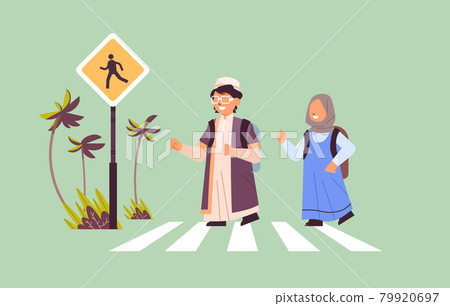 arab schoolchildren crossing road on crosswalk with signboard road safety concept horizontal arab schoolchildren crossing road on crosswalk with signboard road safety concept horizontal 79920697