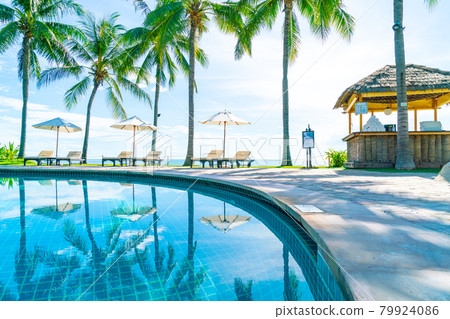 Beautiful umbrella and chair around swimming pool in hotel and resort Beautiful umbrella and chair around swimming pool in hotel and resort 79924086
