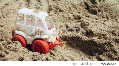 Small white car rides on the sand 79930882