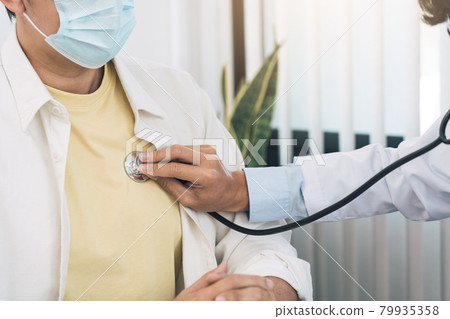 Asian doctor is using a stethoscope listen to the heartbeat of the patient. Asian doctor is using a stethoscope listen to the heartbeat of the patient. 79935358