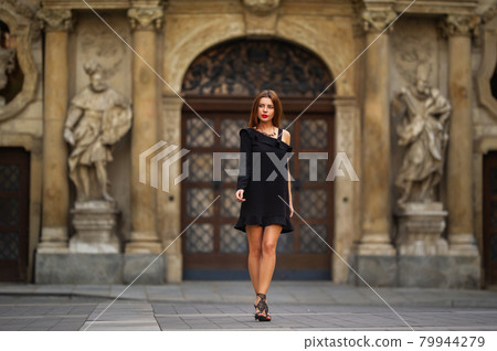 Stylish young girl in a black dress on the street of the city of BRNO in the morning.Czech 79944279