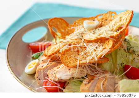Caesar salad with grilled chicken on white wooden background Caesar salad with grilled chicken on white wooden background 79950079
