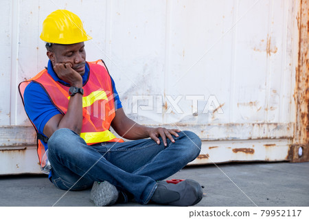 African American foreman or container worker sit and look like sleep to relax after finish his work 79952117