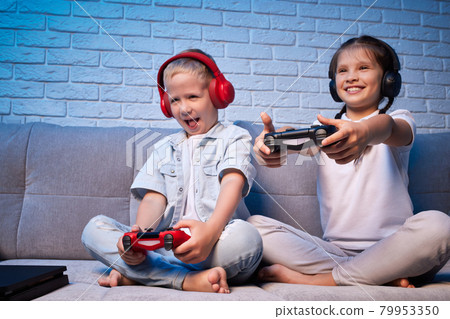 children playing video game with game console children playing video game with game console 79953350