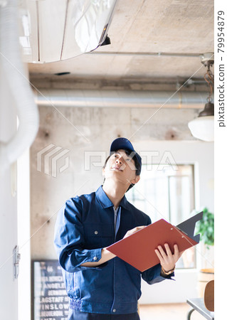 Young worker checking the air conditioner 79954879