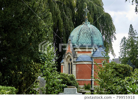 Cemetery with the chapel behind the graves in front of a big willow tree Cemetery with the chapel behind the graves in front of a big willow tree 79955918