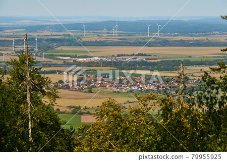 View over the trees to a village in the Vorharz Wind turbines in the flat country, Bad Harzburg, Germany View over the trees to a village in the Vorharz Wind turbines in the flat country, Bad Harzburg, Germany 79955925