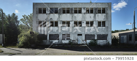 Abandoned office building with windows without glass panes, left to decay, on the former inner-German border Abandoned office building with windows without glass panes, left to decay, on the former inner-German border 79955928