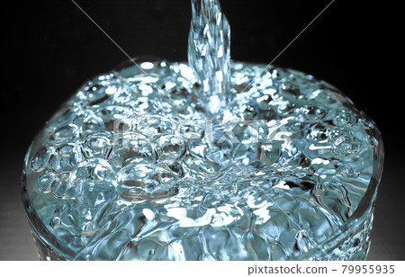 Glass, which is filled with fresh clear water and overflows Glass, which is filled with fresh clear water and overflows 79955935