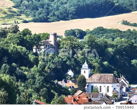 Aerial view of the edge of a village with a historic castle on the Weser in the Weserbergland near Beverungen, Germany Aerial view of the edge of a village with a historic castle on the Weser in the Weserbergland near Beverungen, Germany 79955940