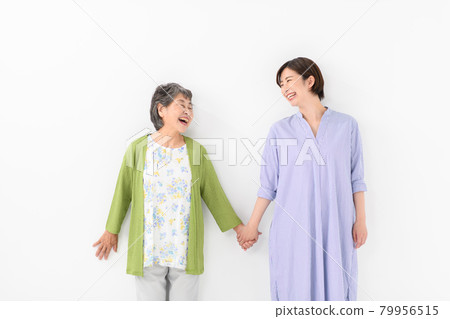 Grandma and granddaughter holding hands Grandma and granddaughter holding hands 79956515