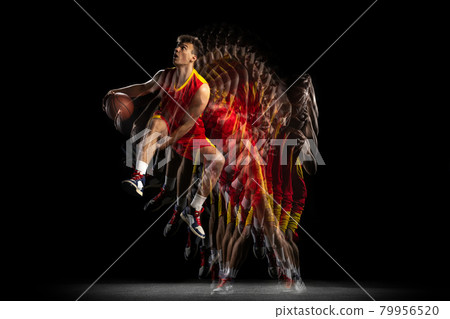 Power and speed. One young basketball player training with ball isolated on dark background with stroboscope effect. Concept of professional sport, hobby. Power and speed. One young basketball player training with ball isolated on dark background with stroboscope effect. Concept of professional sport, hobby. 79956520