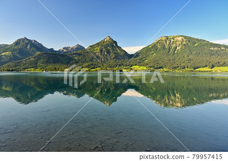Beautiful landscape with lake and mountains in summer. Natural colorful background. Wolfgangsee lake in the Austrian applause. Beautiful landscape with lake and mountains in summer. Natural colorful background. Wolfgangsee lake in the Austrian applause. 79957415