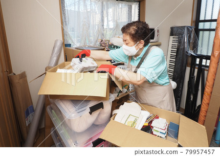 Workers cleaning up cluttered rooms 79957457