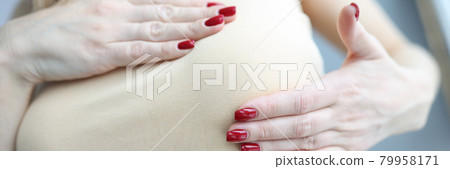 Woman palpating her breasts with hands closeup 79958171