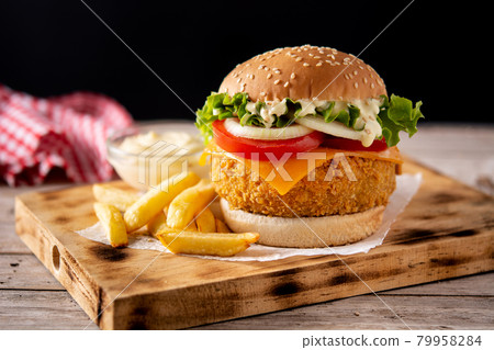 Crispy chicken burger with cheese and french fries 79958284