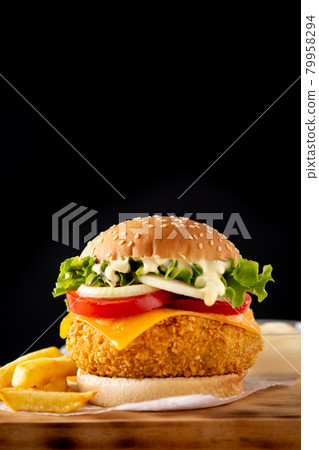 Crispy chicken burger with cheese and french fries Crispy chicken burger with cheese and french fries 79958294