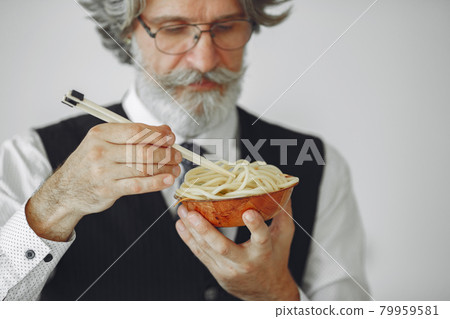 Handsome pensive mature businessman with pasta Handsome pensive mature businessman with pasta 79959581