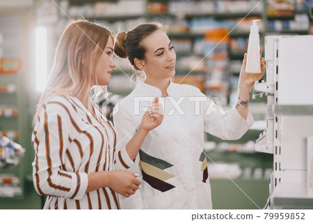 Woman pharmacist checking medicine in pharmacy Woman pharmacist checking medicine in pharmacy 79959852