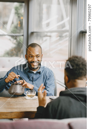 Two colleagues having a conversation with a cup of tea during the break 79960297