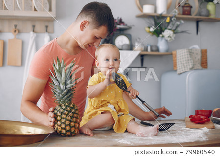 Beautiful family prepare food in a kitchen 79960540